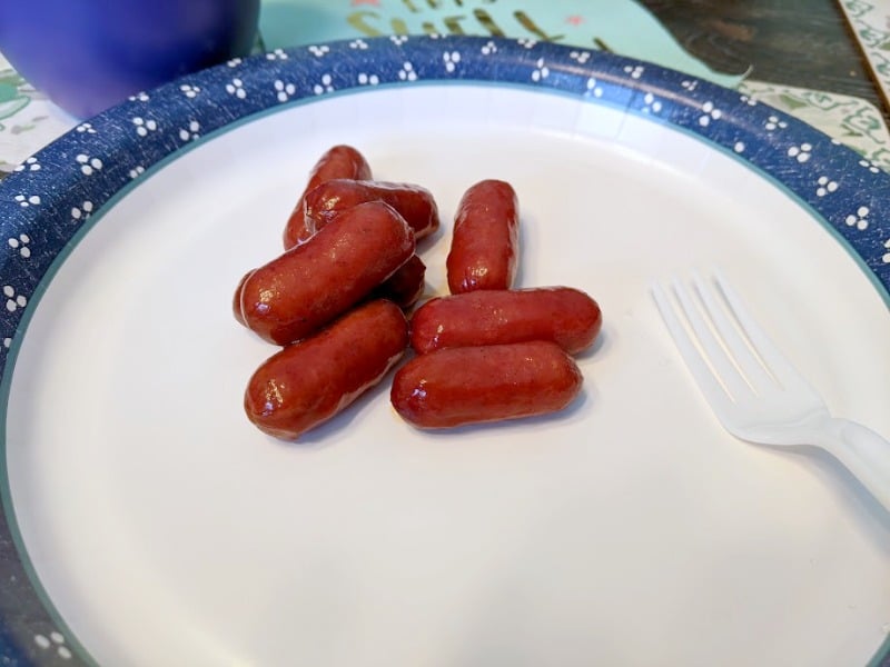 Cocktail wienies on paper plate.