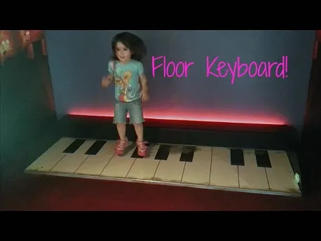 preschool girl on floor piano