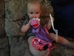 baby boy playing with pajanimal plush