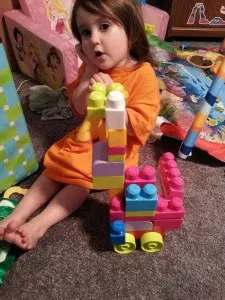 girl building with blocks