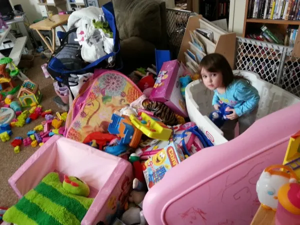 toddler standing in empty toy box in messy room #shop