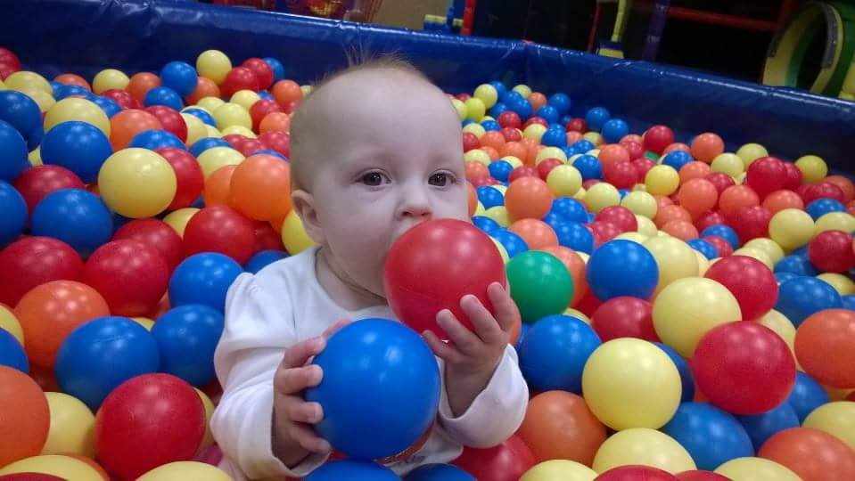 Baby playing in ball pit