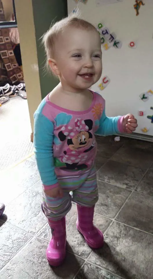 Smiling baby wearing pajamas and boots
