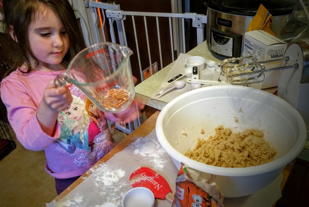 Daughter measuring ingredients for cookies
