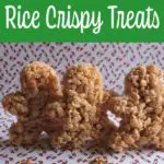 Gingerbread man shaped rice crispy treats standing up on white paper backdrop with little candy canes printed on it.