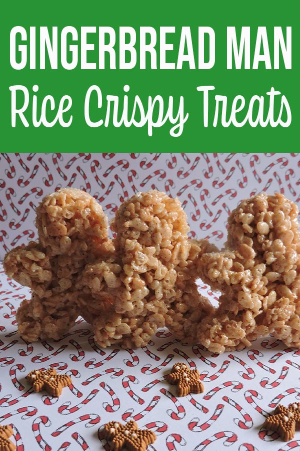 Gingerbread man shaped rice crispy treats standing up on white paper backdrop with little candy canes printed on it.