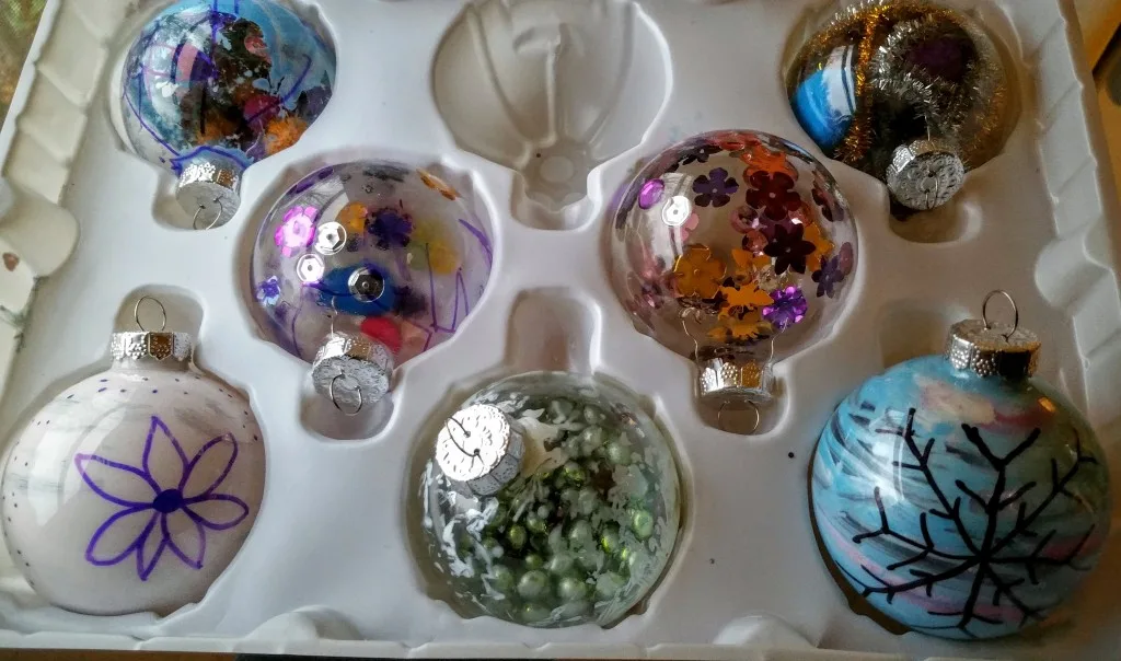 Homemade Christmas ornaments using acrylic paint, sequins, pipe cleaners and more