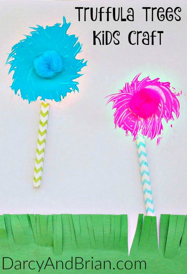 One blue painted truffula tree and one pink with pom pom centers. Each has a chevron striped straw for a trunk.