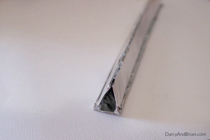 This homemade kaleidoscope does not twist like a real one, but it will look similar when you are done adding this triangular piece covered in aluminum foil!