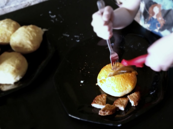 For safe cutting in the kitchen, young kids can use a pizza cutter.