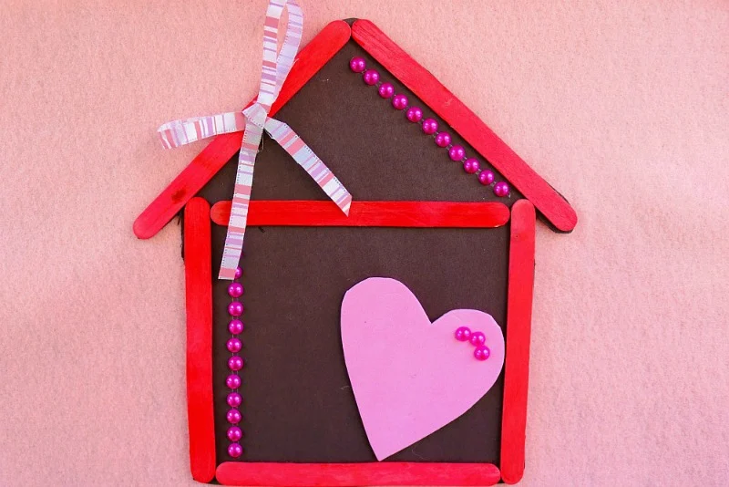 Learn how to make a popsicle stick house magnet. Great craft activity for kids!