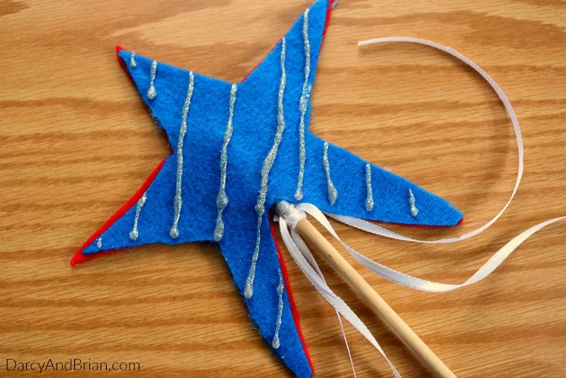 Looking for red, white, and blue kids crafts? This double sided star wand works as a patriotic craft for the Fourth of July or Memorial Day. Help the kids make one of these to take along for the parade!