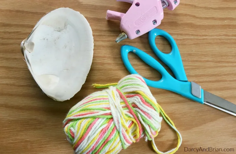 Craft supplies to make a seashell bird feeder.
