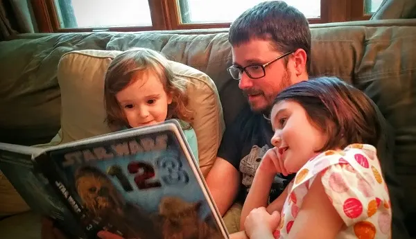 My husband Brian reading Star Wars 123 to our kids.