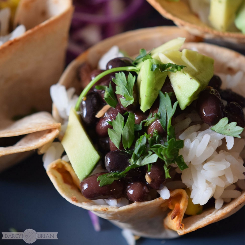 Easy taco cups recipe with black beans, rice, corn, and avocados.