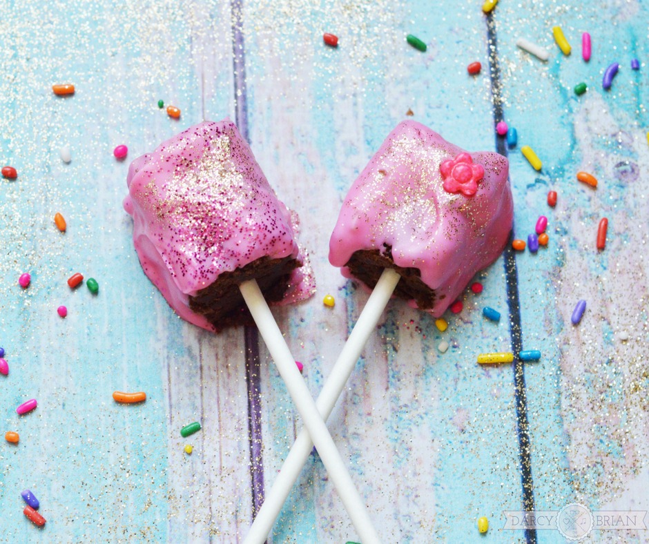 Whether you are planning a princess themed birthday party for girls or a tea party themed baby shower, these Princess Tea Party Glitter Brownie Pops are the ideal treat for your special event. Learn how to make these easy delicious decadent chocolate treats for your party! Click through for step by step instructions. Turn dessert into something magical!