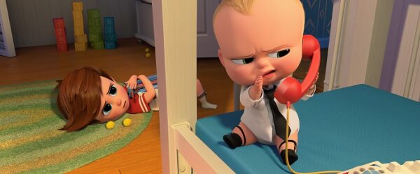Boss Baby Promotion Image - Older brother Tim catches Boss Baby talking on the phone.