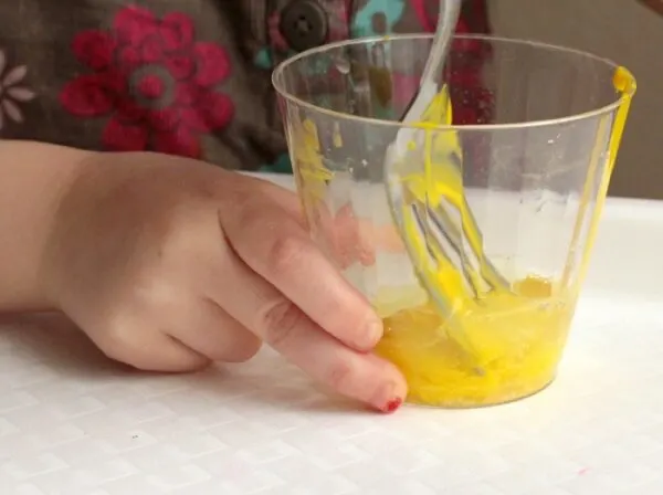 Kids can help mix the playdough during this step.