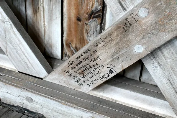 Many people left messages or marks on the wall of the covered bridge.