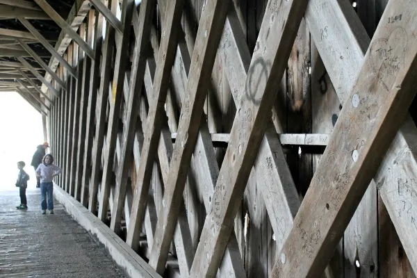 The lattice woodwork inside the covered bridge.