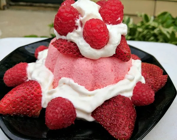 Strawberry angel food cake topped with strawberries and raspberries. Easy to make when all the ingredients are delivered.