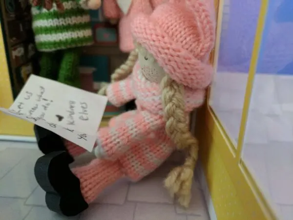 Pink Kindness Elf reading mail