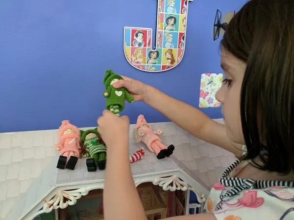 My daughter playing with pink and green Kindness Elves.