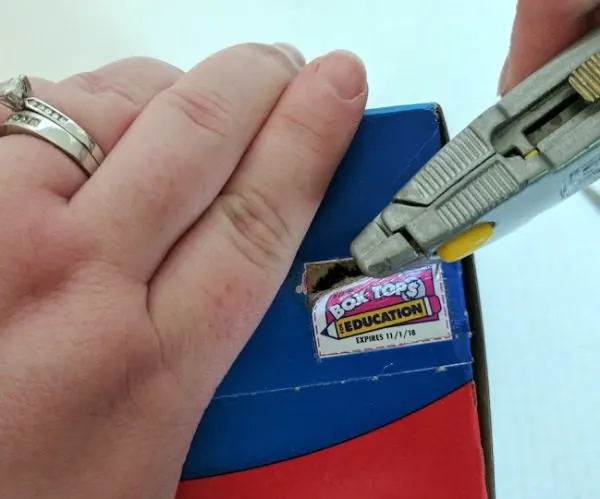 Carefully removing Box Tops with box cutter.
