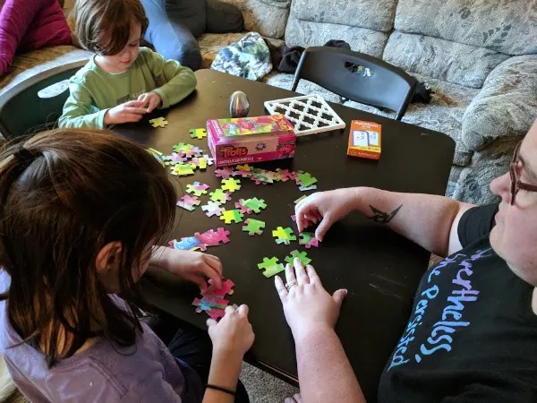 Author working on a puzzle with her kids.