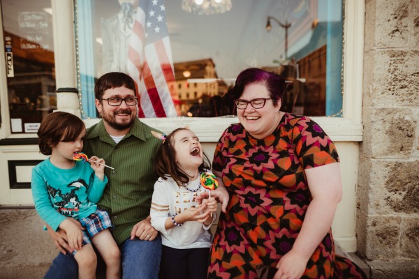 Author and her family laughing during family photo shoot.