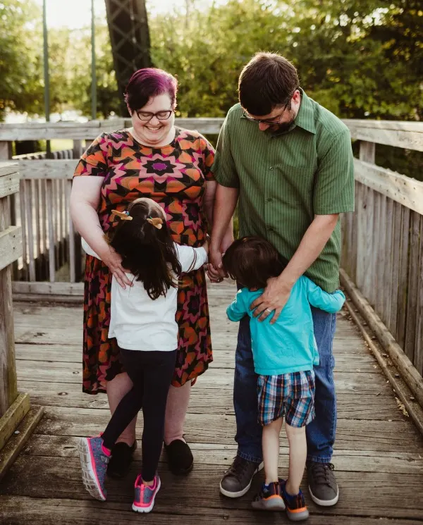 Author's family hugging on a wooden bridge.