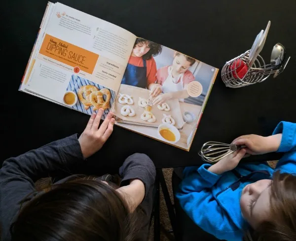 My kids picking out recipes to try from their new cookbook.