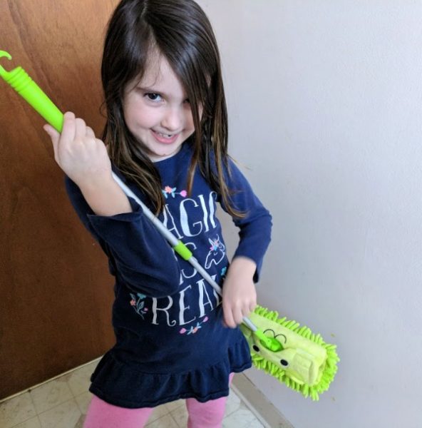 Author's daughter using kids mop as a guitar.
