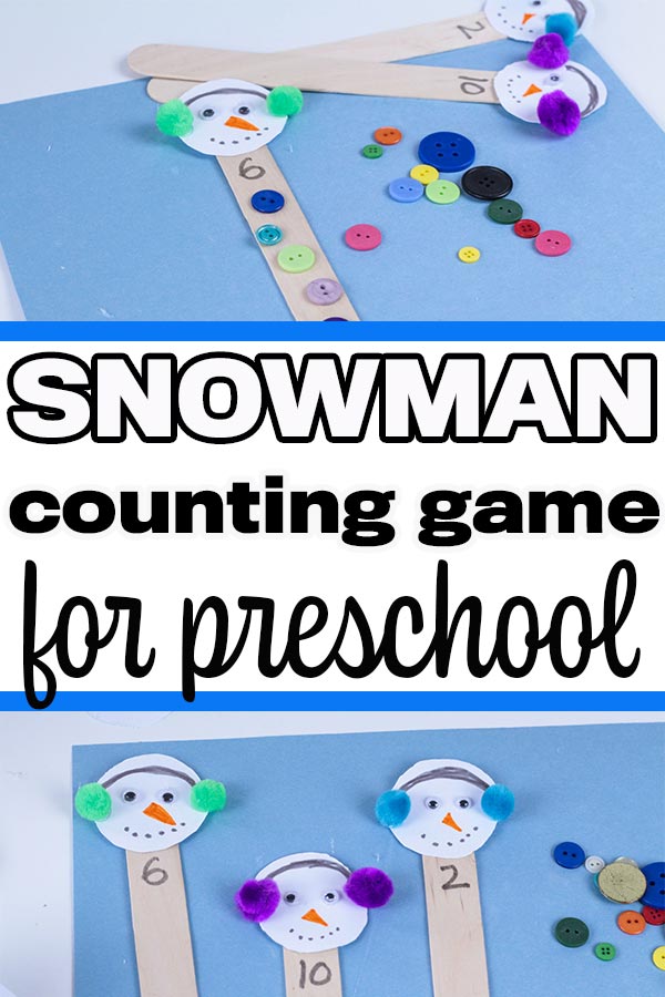 Popsicle sticks decorated with snowman heads laying on blue paper next to assorted buttons.