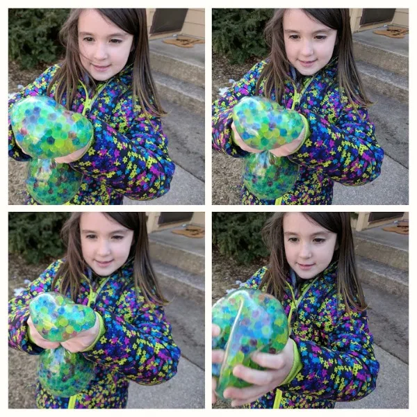 Rissa squishing the huge wubble fulla marbles ball.