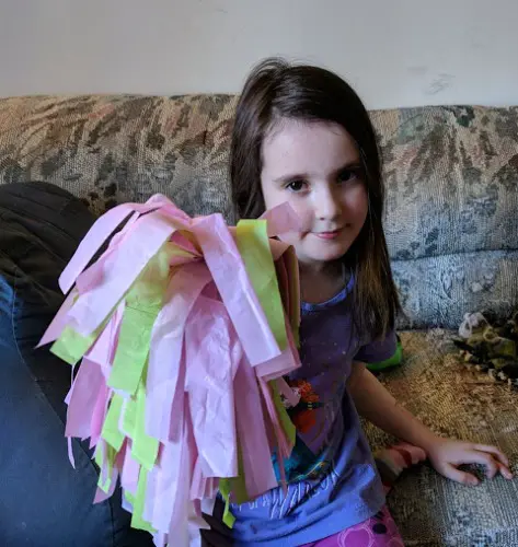 Girl with tissue paper pom pom