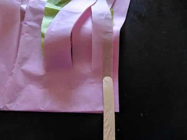 Using craft stick for pom pom handle