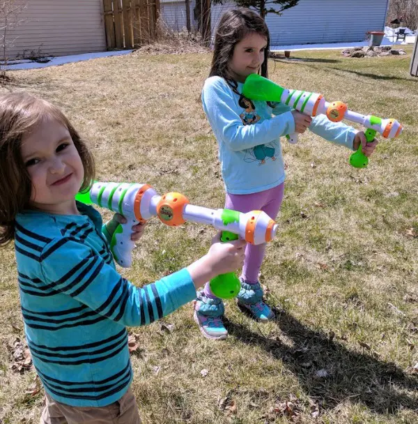 My kids holding Slime Blaster guns, ready to play outside.