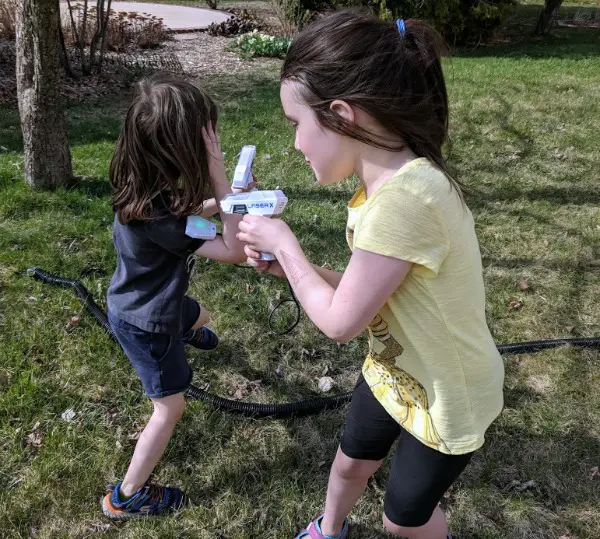 Kids playing outside with Laser X Micro Blaster toys.