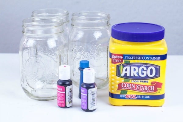 Use simple kitchen ingredients for making oobleck: cornstarch, food coloring, and jars to mix in.