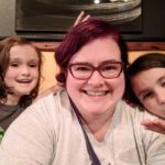 Darcy taking a selfie with her kids.