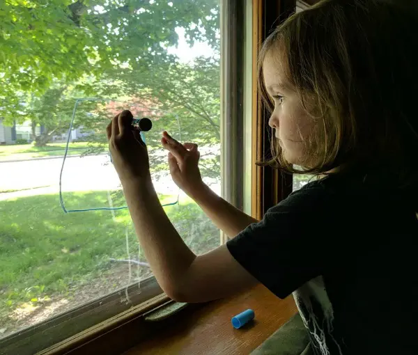 Preschool writing practice on the window