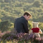 Christopher Robin and Winnie the Pooh sitting together outside