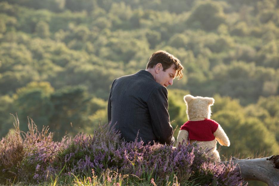 Christopher Robin and Winnie the Pooh sitting together outside