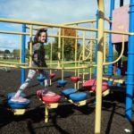 My daughter crossing the playground bridge.
