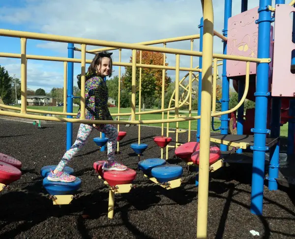 My daughter crossing the playground bridge.