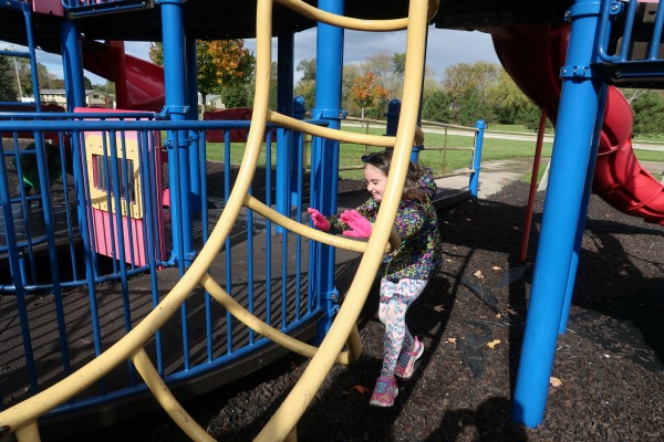 Playing tag around the playground equipment at Centennial Park