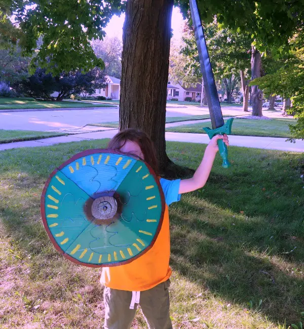 Author's son with homemade shield and plastic sword