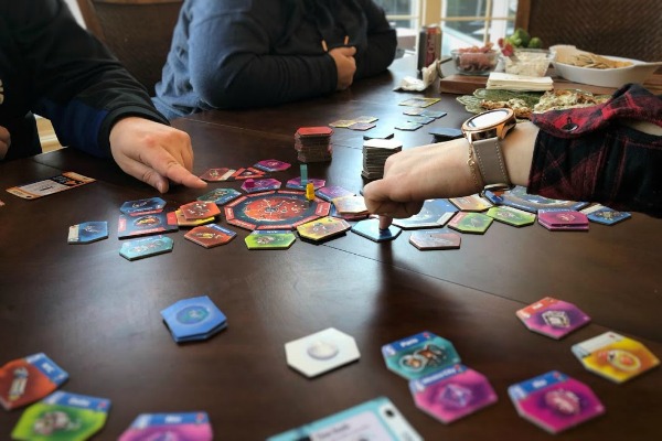 People playing Junk Orbit board game.