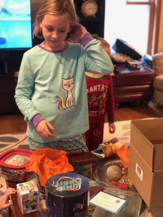 Girl looking at items from the family gaming subscription box